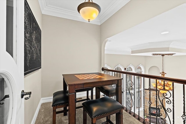 dining room featuring carpet flooring, an inviting chandelier, and ornamental molding