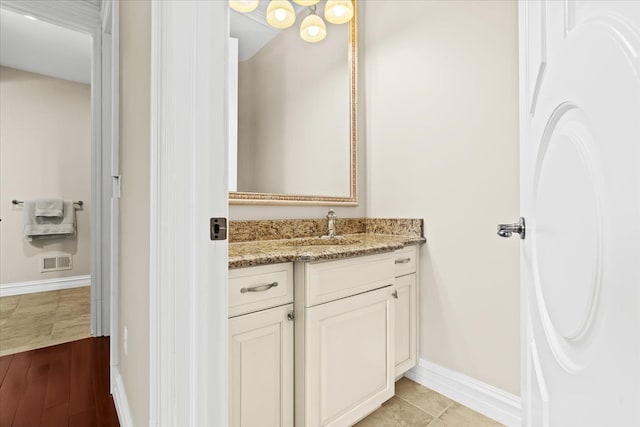 bathroom featuring tile patterned flooring and vanity