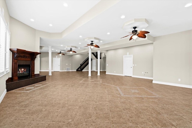 unfurnished living room with ceiling fan