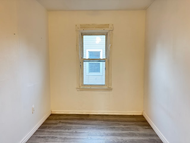 empty room featuring dark hardwood / wood-style flooring