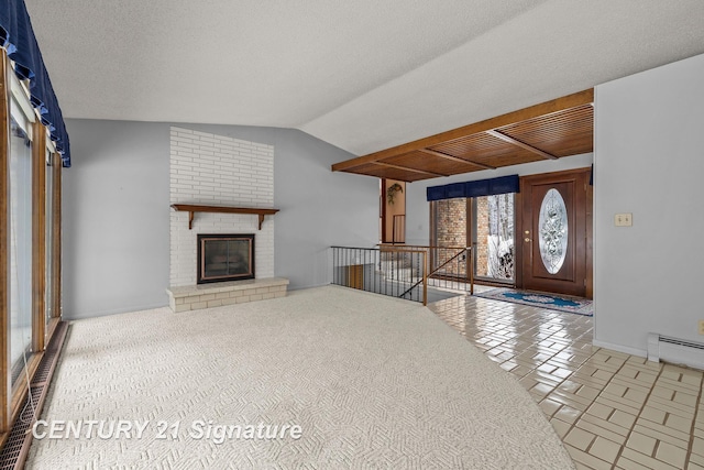 unfurnished living room featuring a fireplace, a baseboard heating unit, a textured ceiling, and lofted ceiling