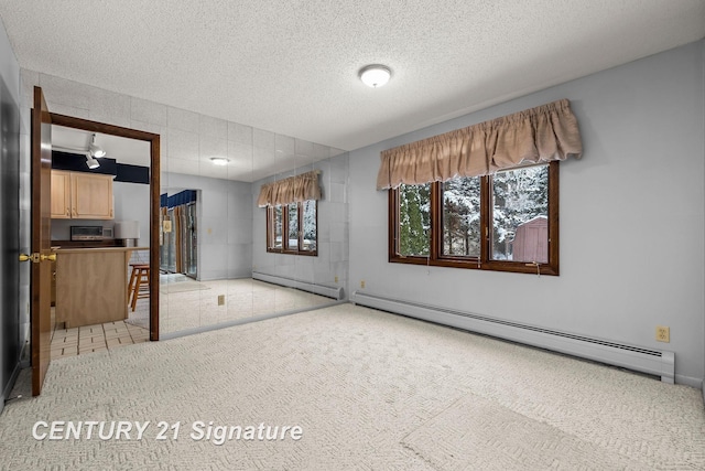 interior space featuring a textured ceiling and a baseboard radiator