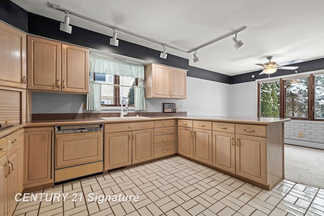 kitchen featuring ceiling fan, dishwasher, sink, kitchen peninsula, and track lighting