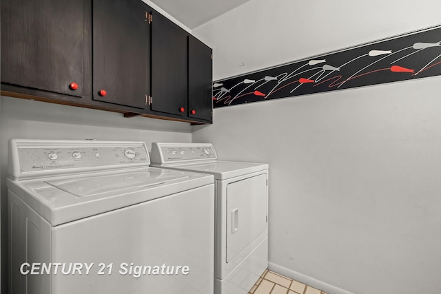 laundry area featuring cabinets, washing machine and dryer, and light tile patterned flooring