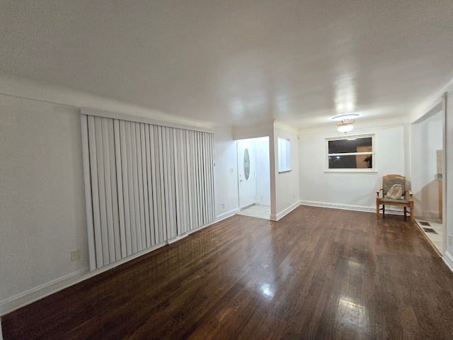 unfurnished living room with dark hardwood / wood-style flooring