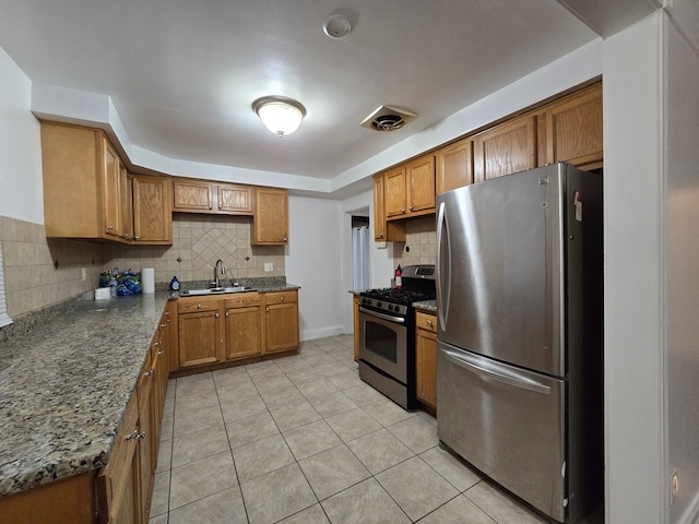 kitchen featuring decorative backsplash, sink, light tile patterned flooring, and stainless steel appliances