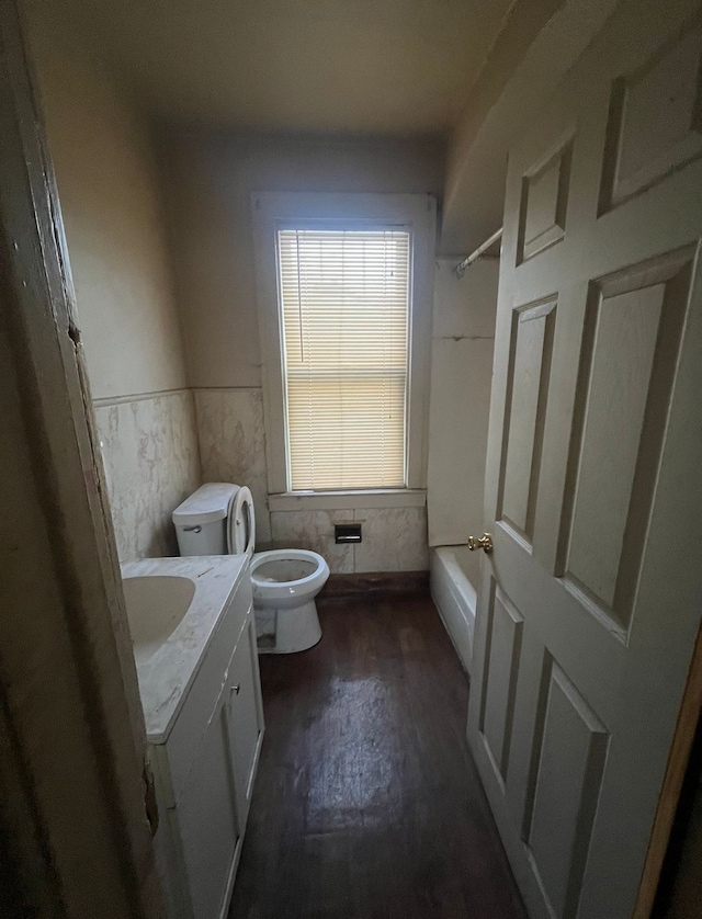 full bathroom with hardwood / wood-style floors, vanity, toilet, and shower / bathtub combination