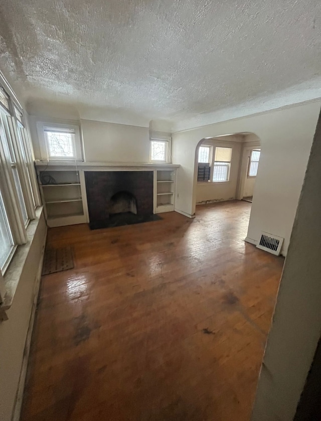 unfurnished living room with a textured ceiling