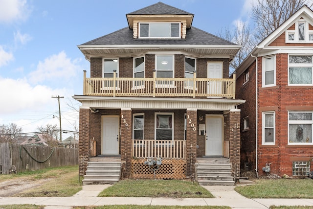 view of front facade featuring a balcony and covered porch