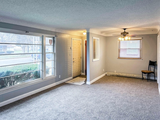 unfurnished bedroom featuring a textured ceiling, carpet floors, and ceiling fan