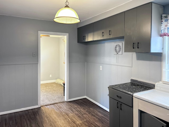 kitchen with gray cabinetry, dark hardwood / wood-style floors, and hanging light fixtures