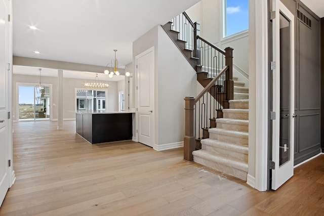 interior space featuring hardwood / wood-style flooring and a notable chandelier