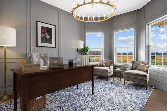 office space featuring hardwood / wood-style floors and an inviting chandelier