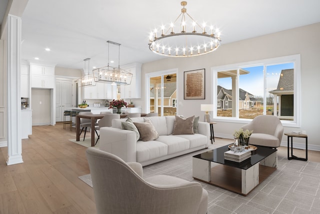 living room featuring light hardwood / wood-style floors and a notable chandelier