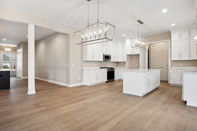 54673 Ann Dr, Macomb, MI 48042 - kitchen with a notable chandelier, light countertops, stainless steel appliances, white cabinets, and light wood-style floors