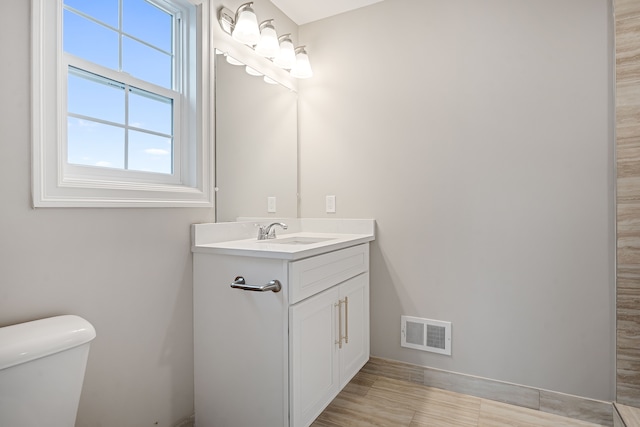 54673 Ann Dr, Macomb, MI 48042 - bathroom with visible vents, toilet, and vanity