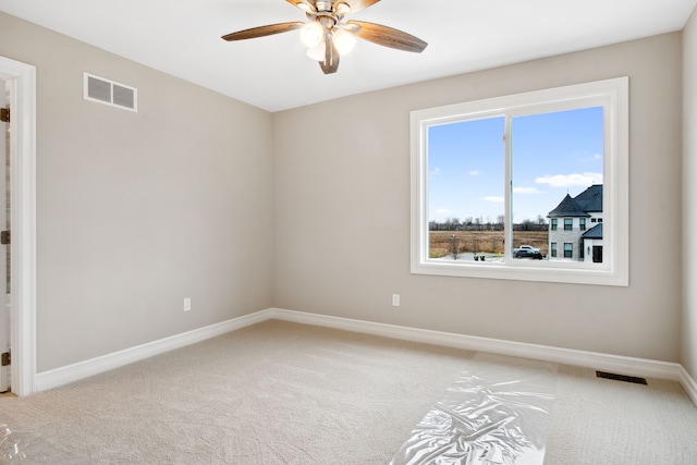 empty room featuring ceiling fan and carpet flooring