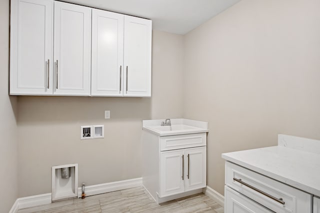 laundry room with cabinets, gas dryer hookup, sink, and washer hookup