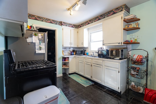 kitchen featuring stainless steel appliances, white cabinets, decorative backsplash, and tile countertops