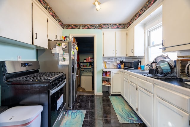 kitchen featuring stainless steel appliances, tile counters, and white cabinets