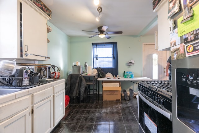 kitchen with tile countertops, stainless steel refrigerator with ice dispenser, gas stove, white cabinetry, and ceiling fan