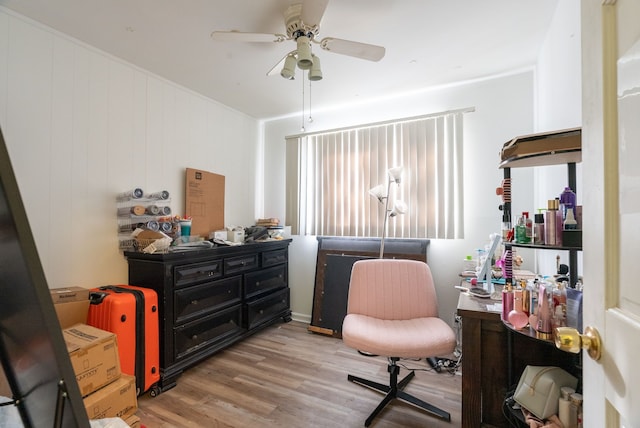 office with light wood-type flooring and ceiling fan