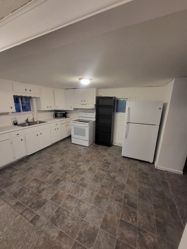 kitchen featuring white cabinets, a textured ceiling, white appliances, and sink