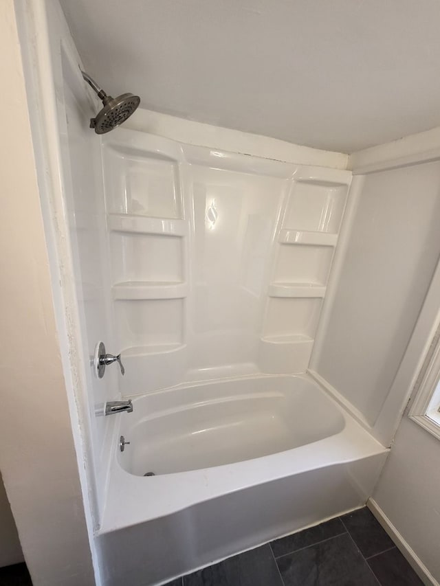 bathroom with tile patterned flooring and shower / bath combination