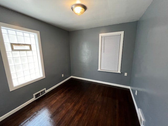 spare room with dark hardwood / wood-style floors