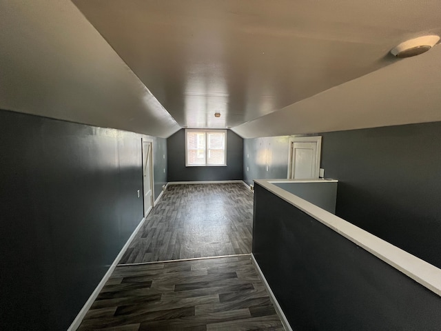 additional living space with dark hardwood / wood-style floors and lofted ceiling