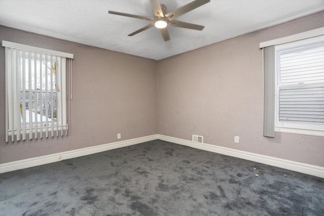 carpeted empty room featuring ceiling fan