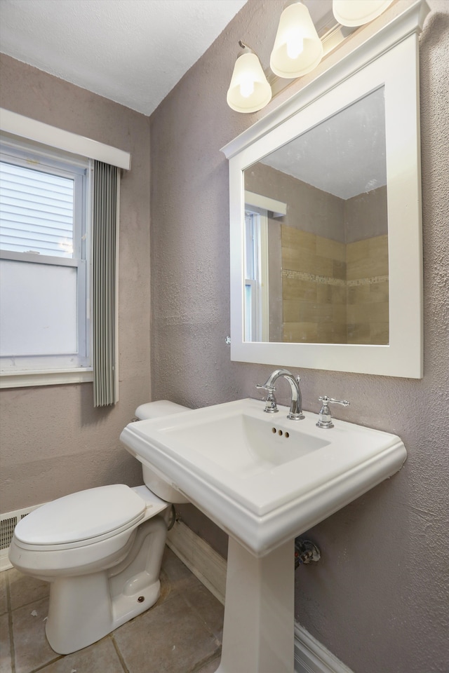 bathroom featuring tile patterned flooring, toilet, and sink