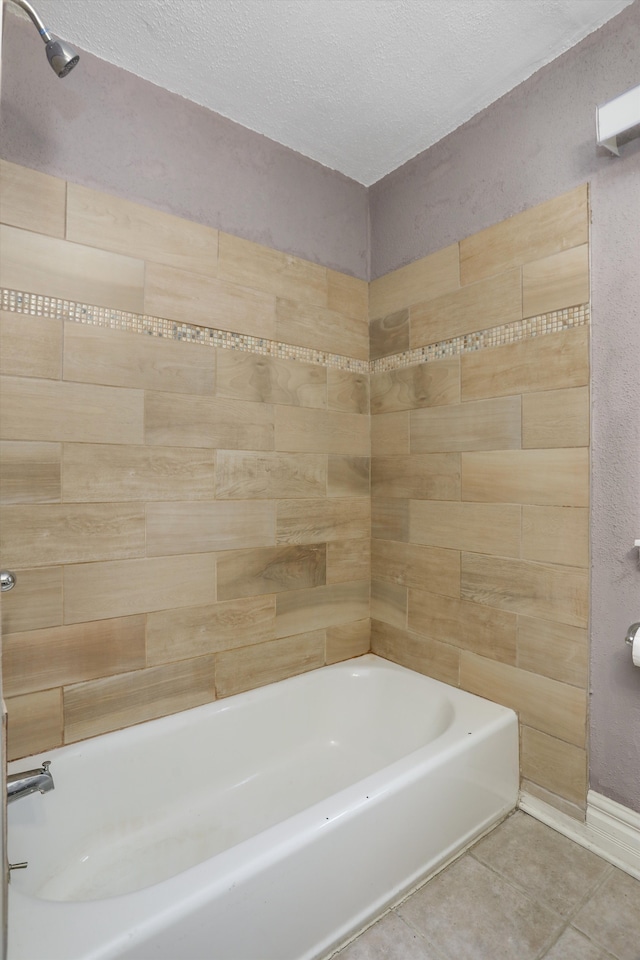 bathroom with a textured ceiling, tile patterned flooring, and bathtub / shower combination