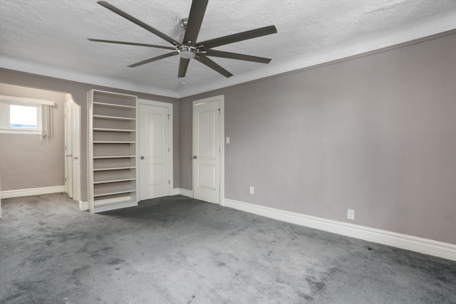 unfurnished bedroom featuring dark colored carpet, ceiling fan, and a textured ceiling