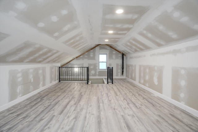 bonus room featuring light hardwood / wood-style flooring and vaulted ceiling