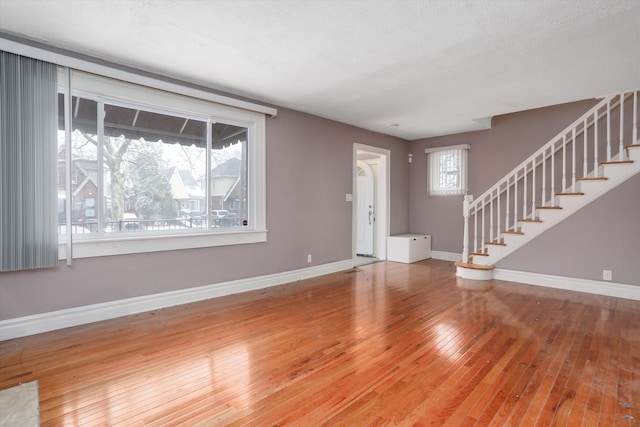 foyer entrance featuring hardwood / wood-style flooring and a textured ceiling