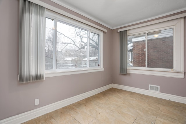 empty room with plenty of natural light and ornamental molding