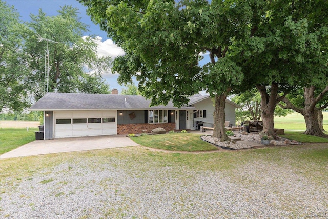 ranch-style house featuring a front yard and a garage