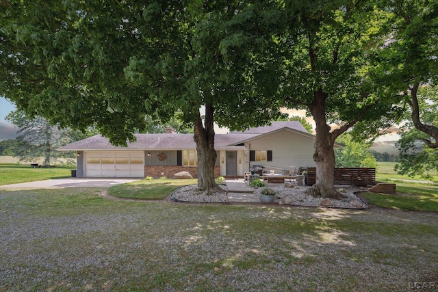 ranch-style home with a front yard and a garage