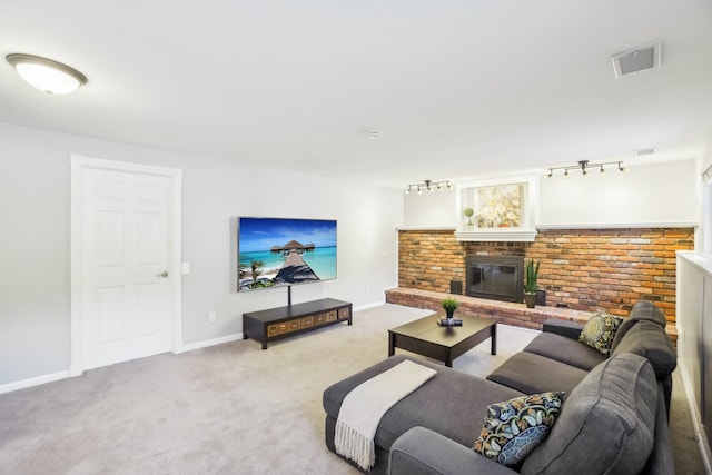 living area featuring light carpet, baseboards, visible vents, a brick fireplace, and track lighting