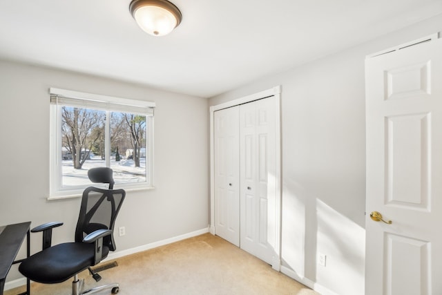 office space with baseboards and light colored carpet