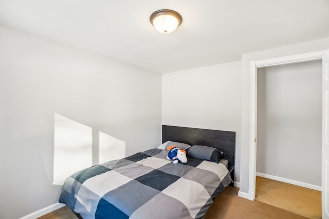 bedroom featuring carpet and baseboards