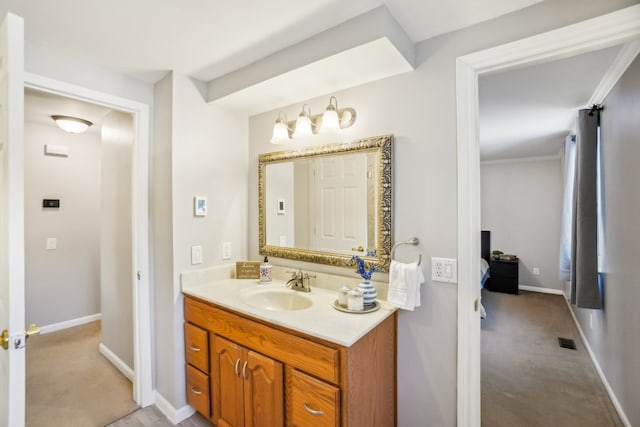 bathroom featuring baseboards, visible vents, and vanity