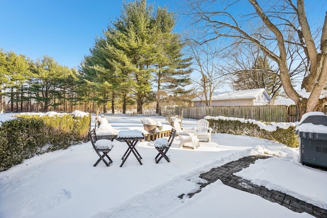 yard layered in snow featuring fence