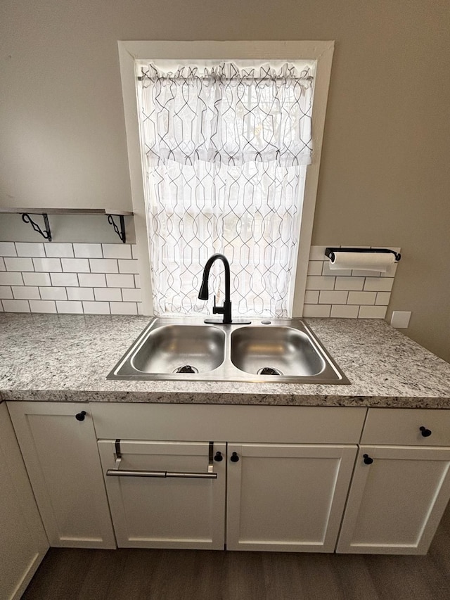 kitchen with white cabinetry, sink, tasteful backsplash, and dark hardwood / wood-style flooring