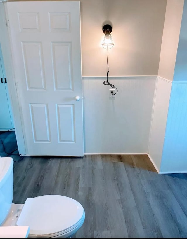 bathroom with hardwood / wood-style floors and toilet