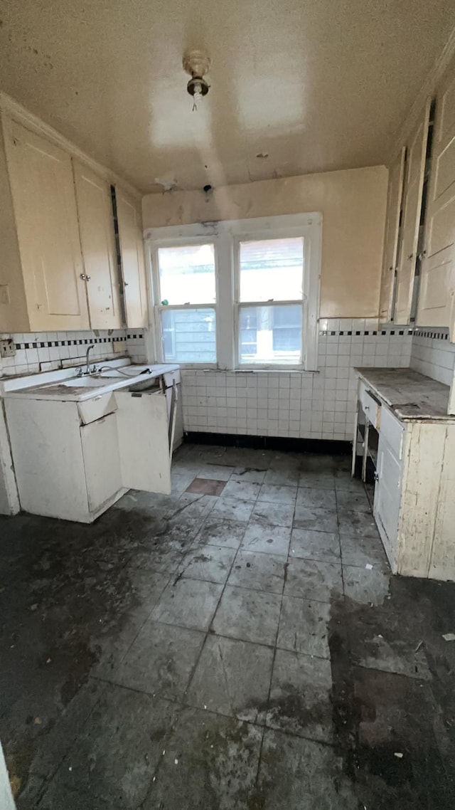 kitchen with backsplash and white cabinetry