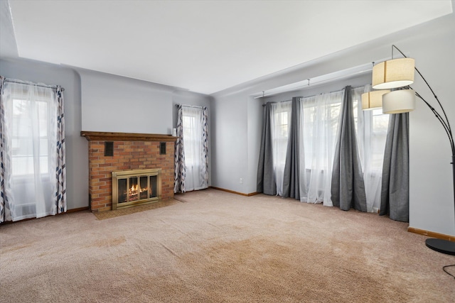 carpeted living room with a fireplace and a wealth of natural light