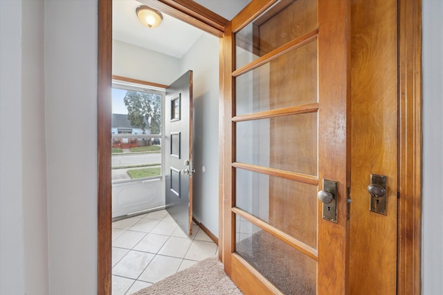 doorway with light tile patterned floors