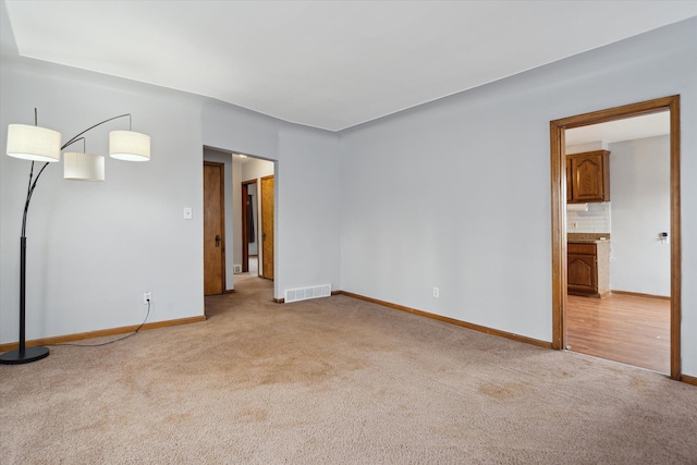 unfurnished room with light carpet